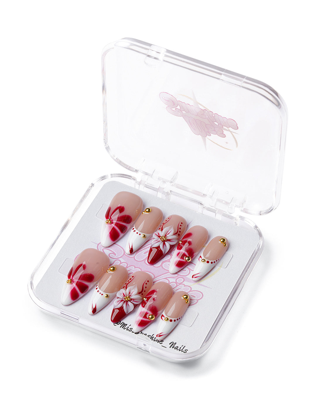Nude nails with red flower designs, sculpted petals, and crystal detailing