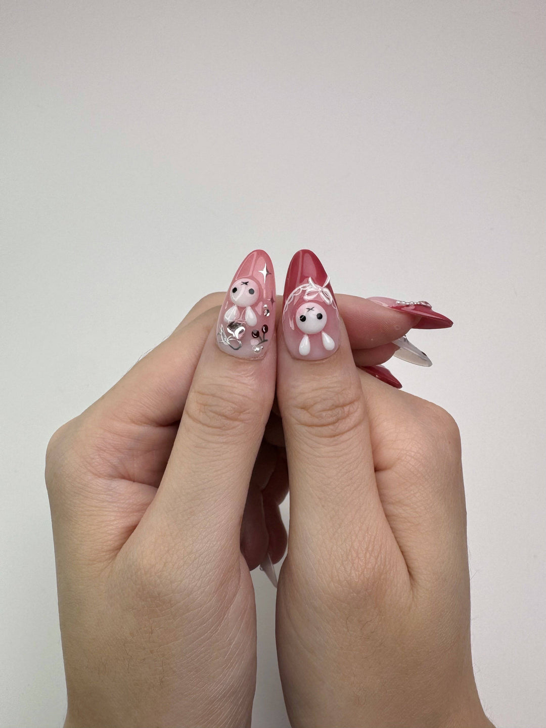 Girly press-on nails with pink base and 3D accents