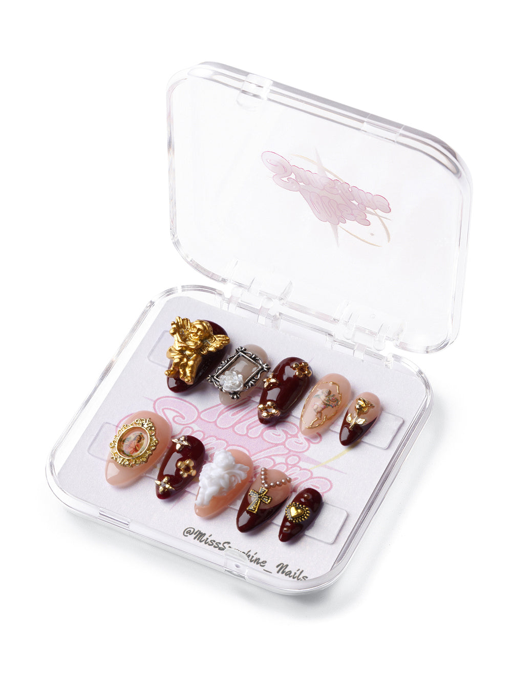 Saintly Love short almond press-on nails with cherubs, gold crosses, antique frames, and vintage-inspired embellishments.