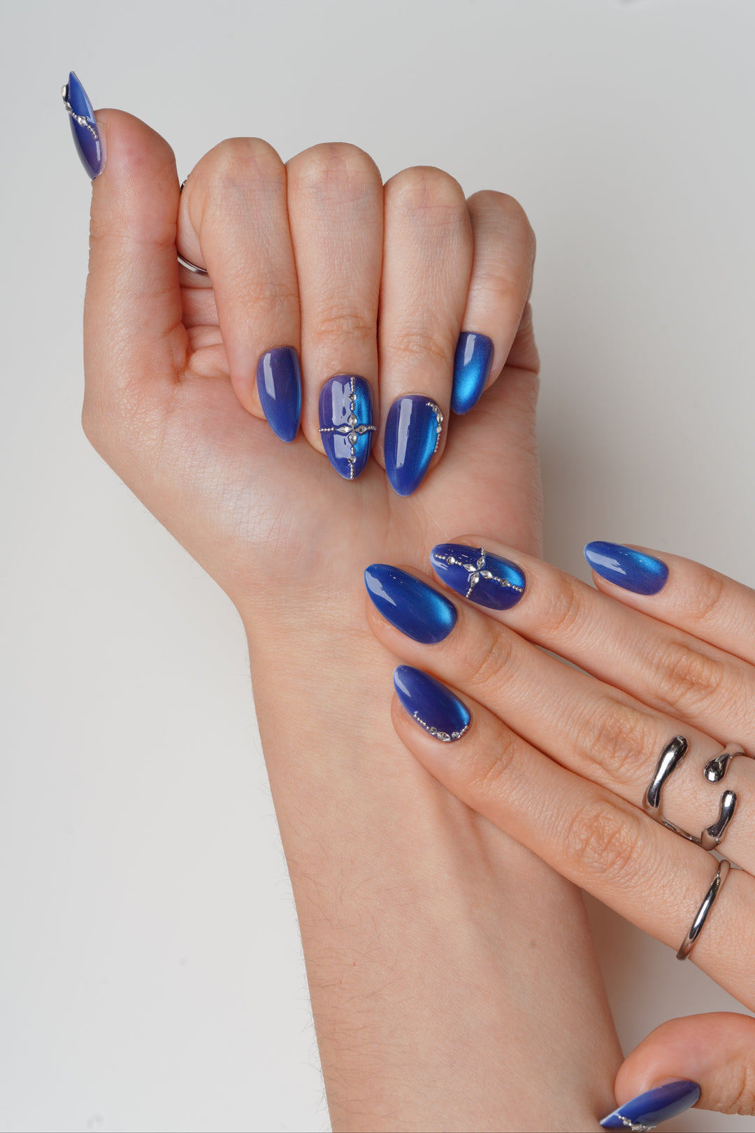 extra short almond Bold blue prom nails with crystal accents
