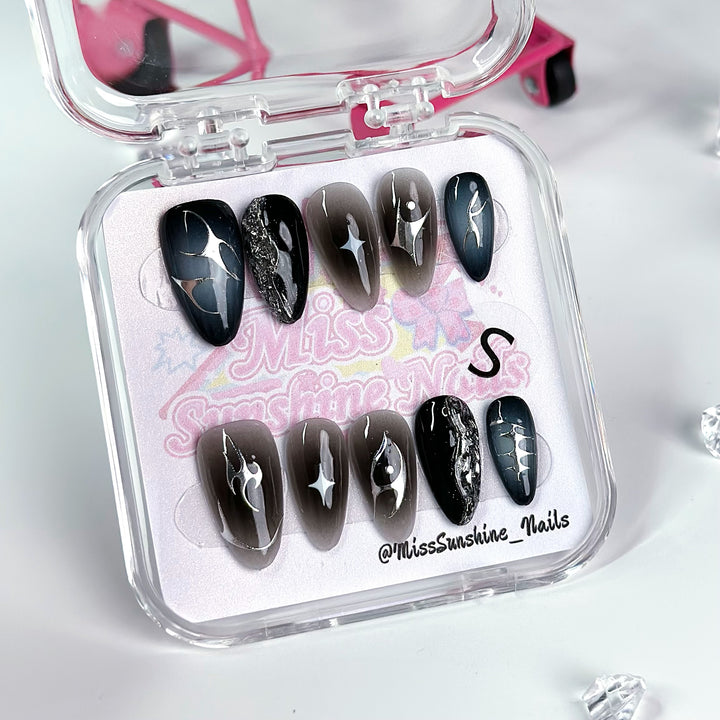 Black and brown ombré nails with star designs