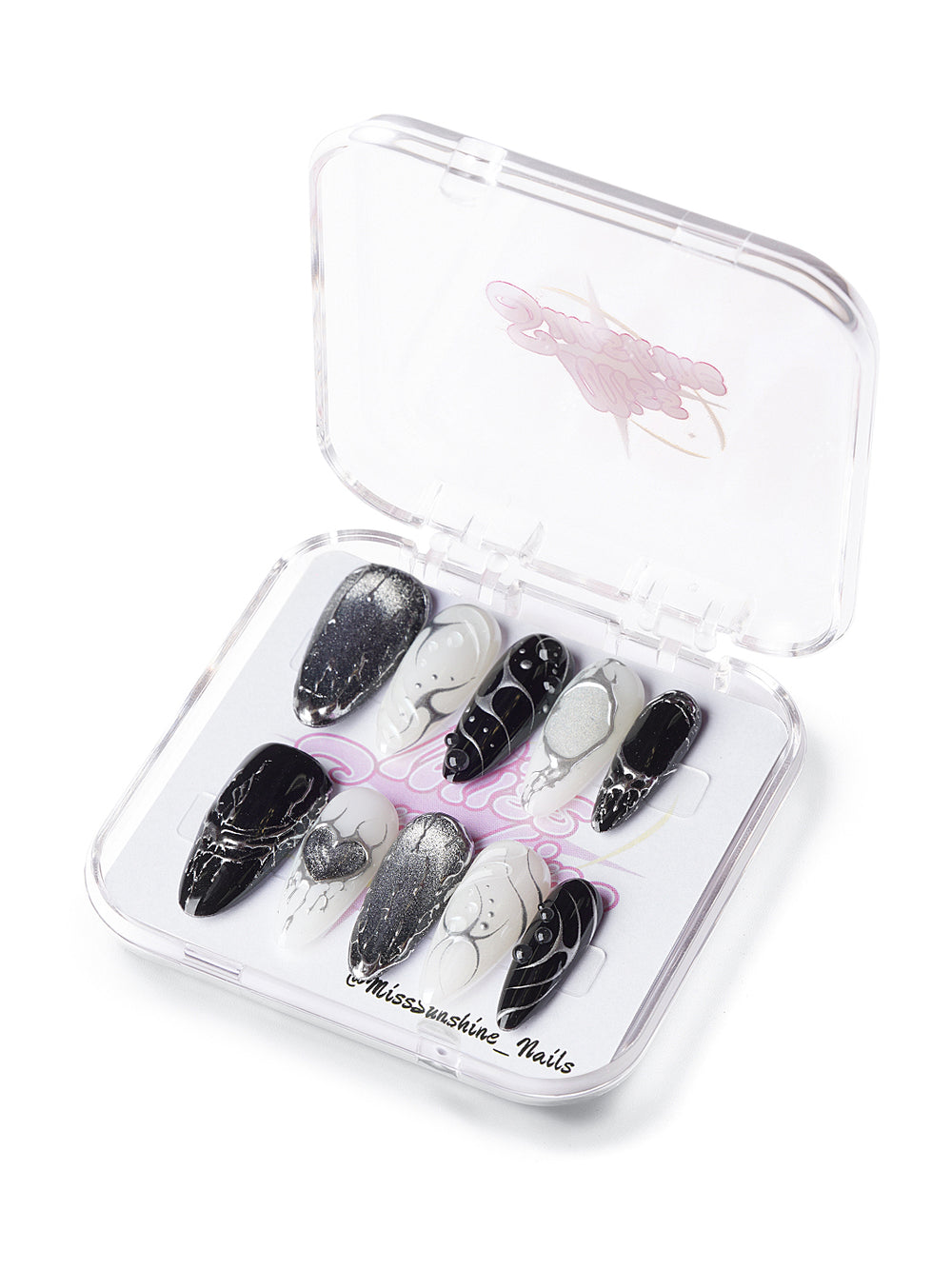 Long almond press-on nails in black and white with chrome lightning and heart designs