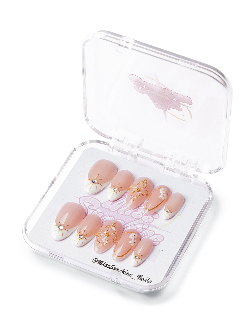 Short almond press-on nails with peach nude base, gold linework, white floral accents, and 3D blossoms