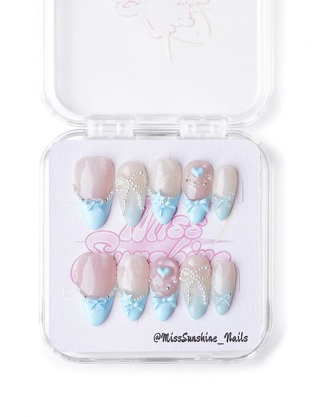 Short almond pastel winter nails with bows, pearls, and nude-to-blue gradients
