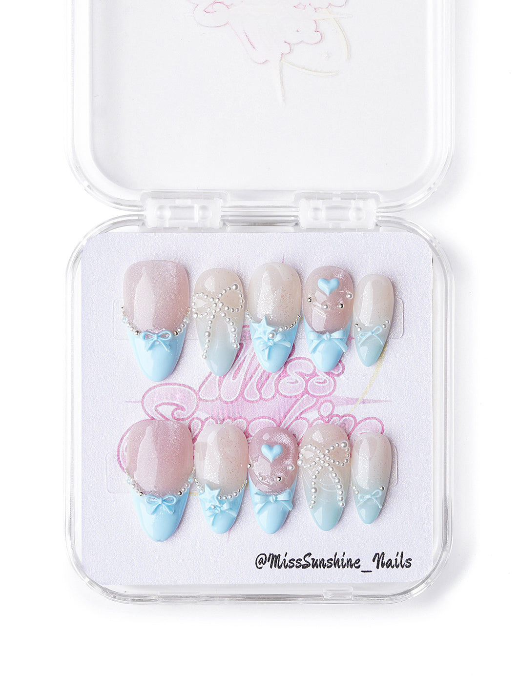 Short almond pastel winter nails with bows, pearls, and nude-to-blue gradients