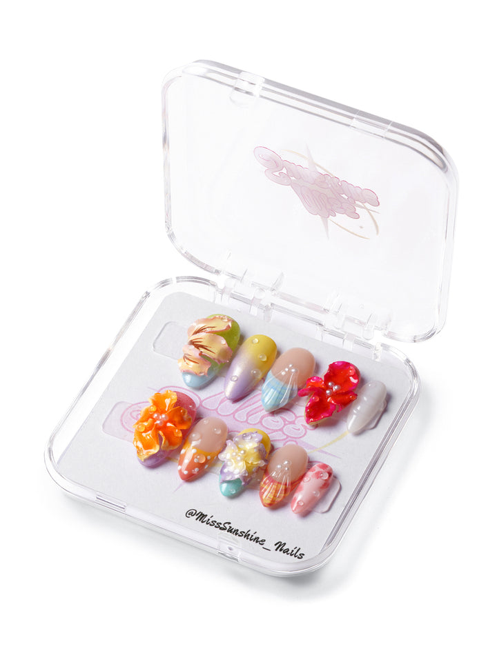 Short almond nails with 3D flowers, shell accents, colorful gradients, and playful textures