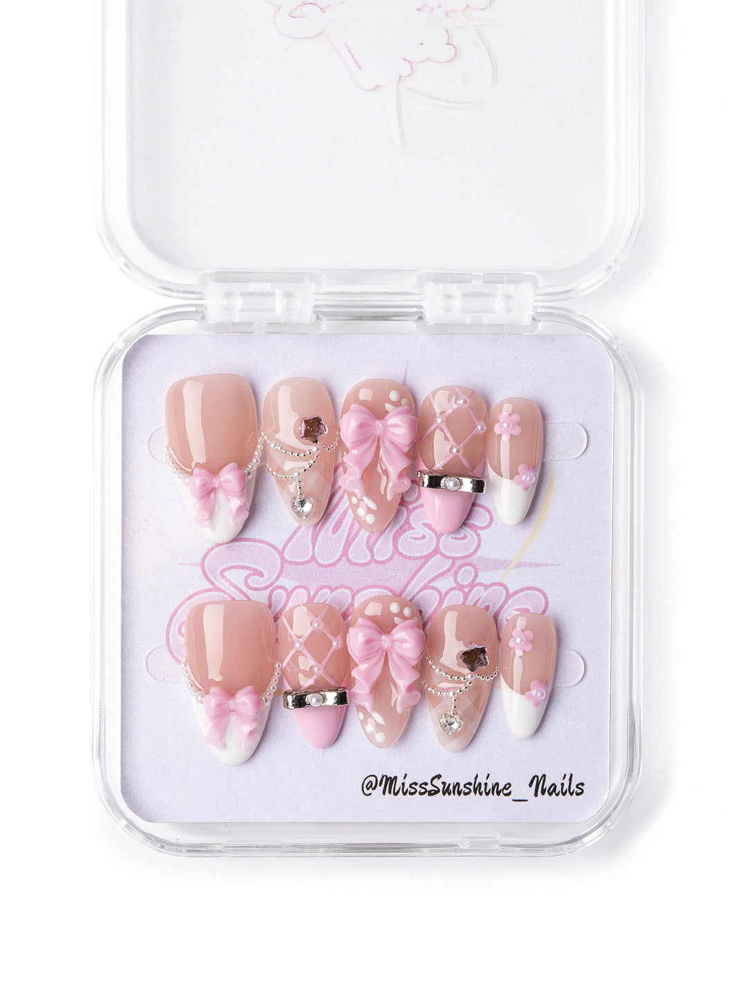 Valentine’s Day press-on nails featuring elegant nude and white designs with intricate 3D embellishments and chains.