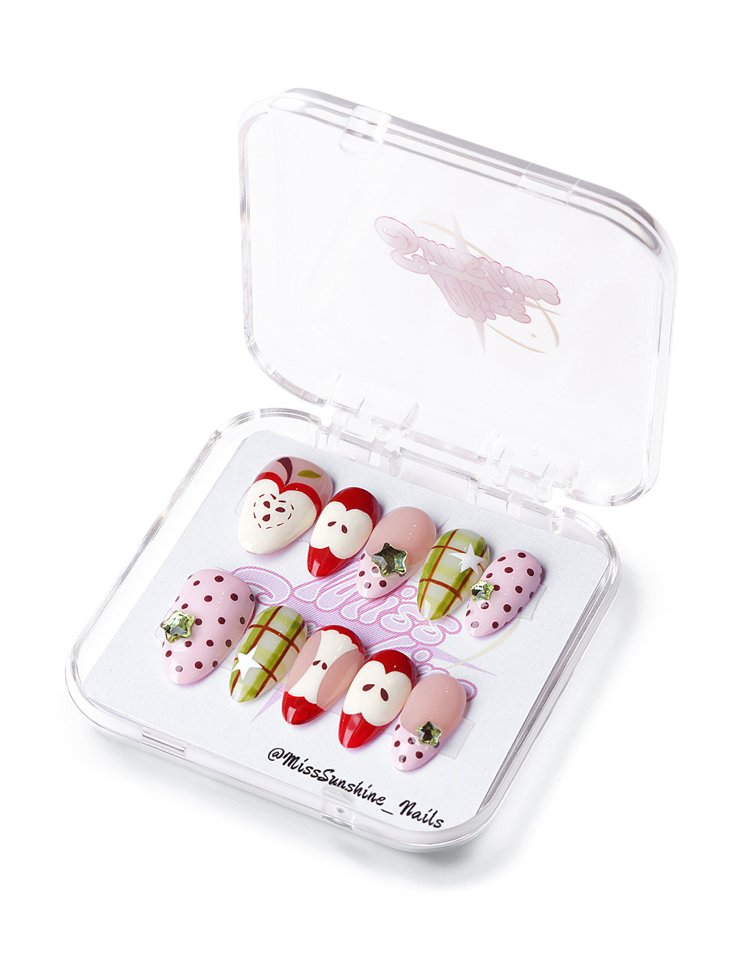 short almond nails with apple designs, green plaid, pink polka dots, and star foil decals