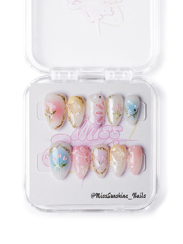 Handmade press-on nails with vintage-inspired garden design in soft spring colors