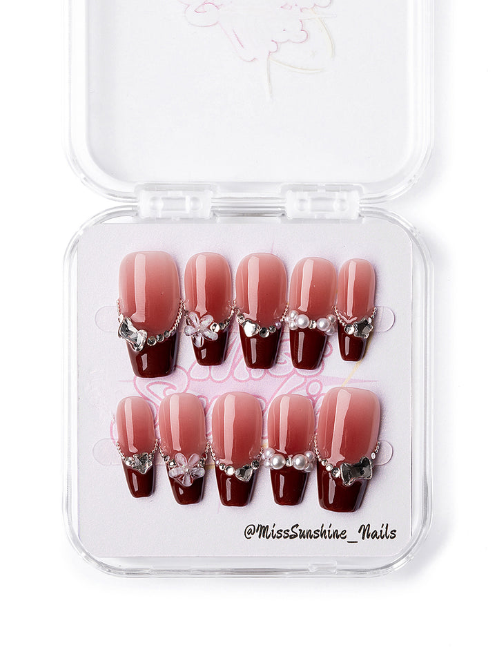 Miss Sunshine handmade nail art with red tips and jewelry elements