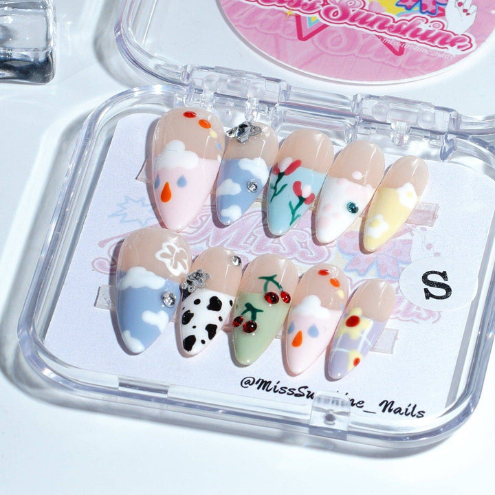 Long almond nails with clouds